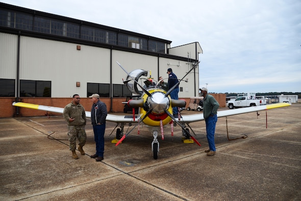 Members of Team BLAZE talk to Retiree Appreciation Day guests in front of a T-6 Texan II Nov. 14, 2019, on Columbus Air Force Base, Miss. During the event, retirees were treated with a free lunch buffet, raffle prizes, a medical expo and free flu shots. (U.S. Air Force photo by Airman 1st Class Jake Jacobsen)