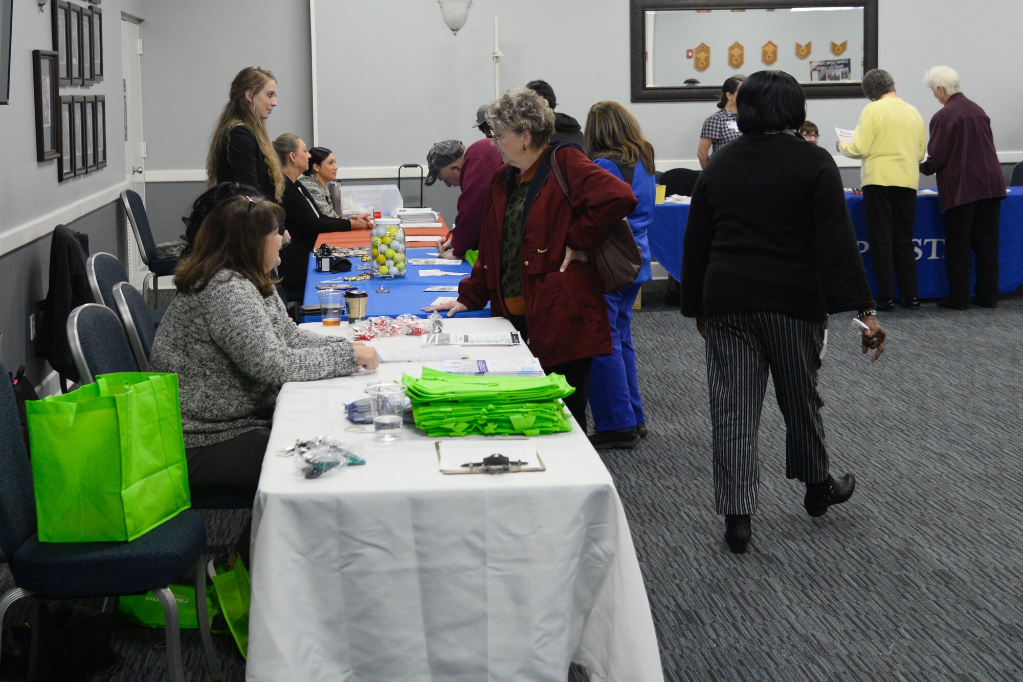 Volunteers at the information booths talk to guests during Retiree Appreciation Day at the Columbus Club Nov. 14, 2019, on Columbus Air Force Base, Miss. The retirees and veterans received information from base agencies such as the pharmacy and TRICARE and community information from various agencies. (U.S. Air Force photo by Airman 1st Class Jake Jacobsen)