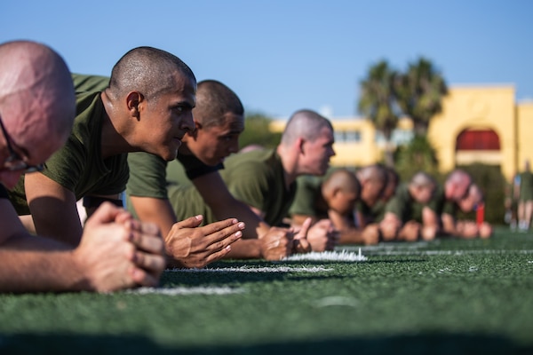 Recruits hold the plank position.