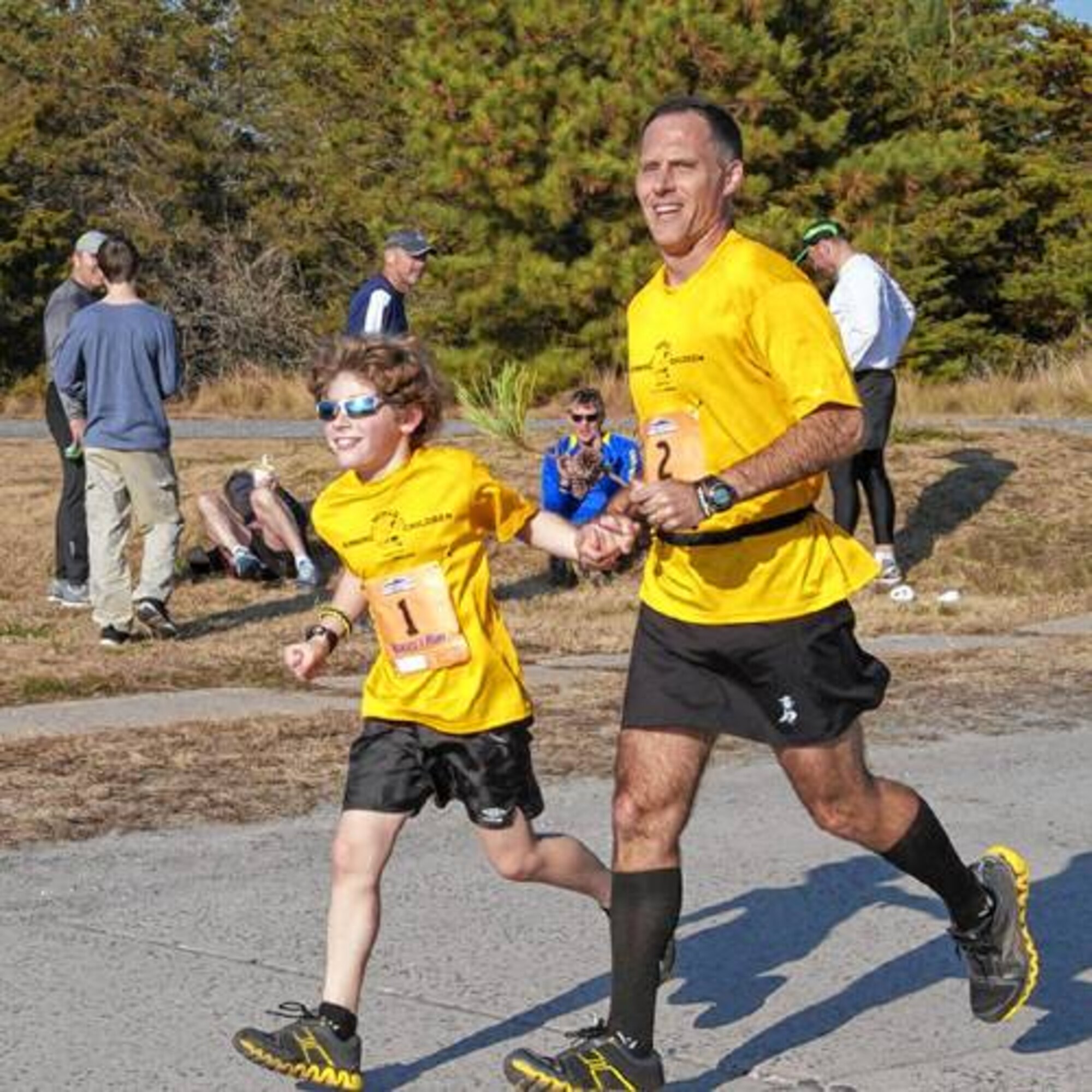 Lt. Col. (Dr.) Daniel Toocheck runs a marathon with his son, Nikolas.