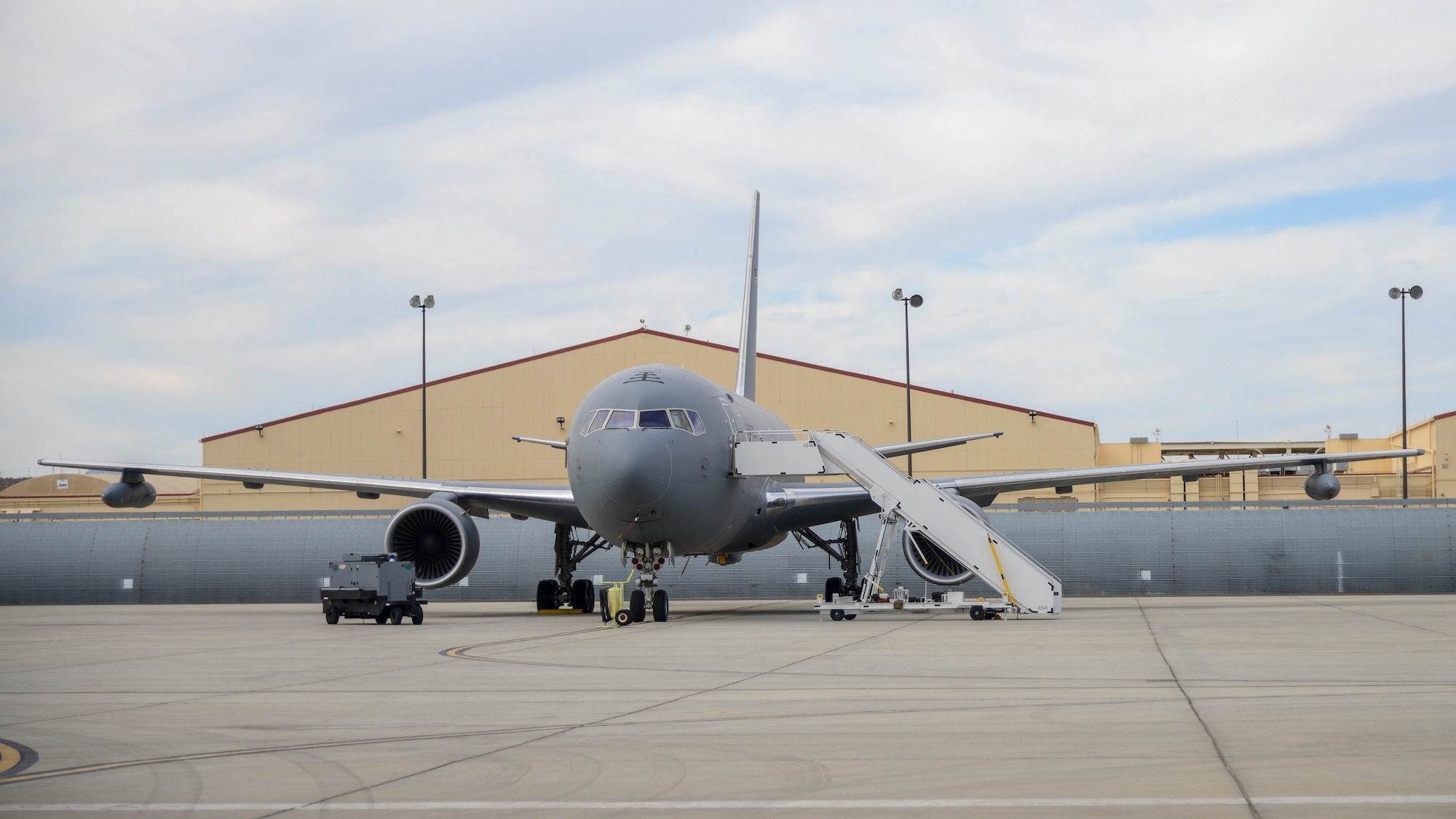 A KC-46 Pegasus is parked at a ramp at Edwards Air Force Base, California, with a Wing Aerial Refueling Pod (WARP) on each wing. The KC-46 Pegasus recently finished WARPs testing with an AV-8B and F-18D/G. The WARPs system allows the Pegasus to simultaneously refuel two aircraft via drogue chutes. (U.S. Air Force photo by Giancarlo Casem)