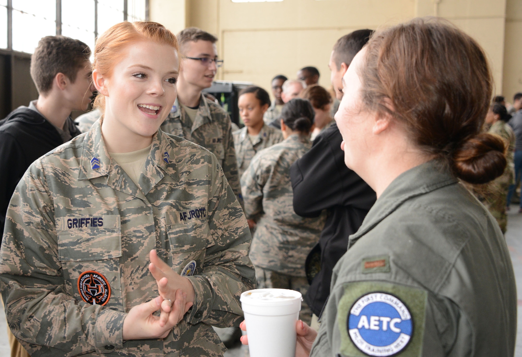 An Air Force mentor talks to a student during the Aim High Outreach event at Maxwell Air Force Base, Alabama.