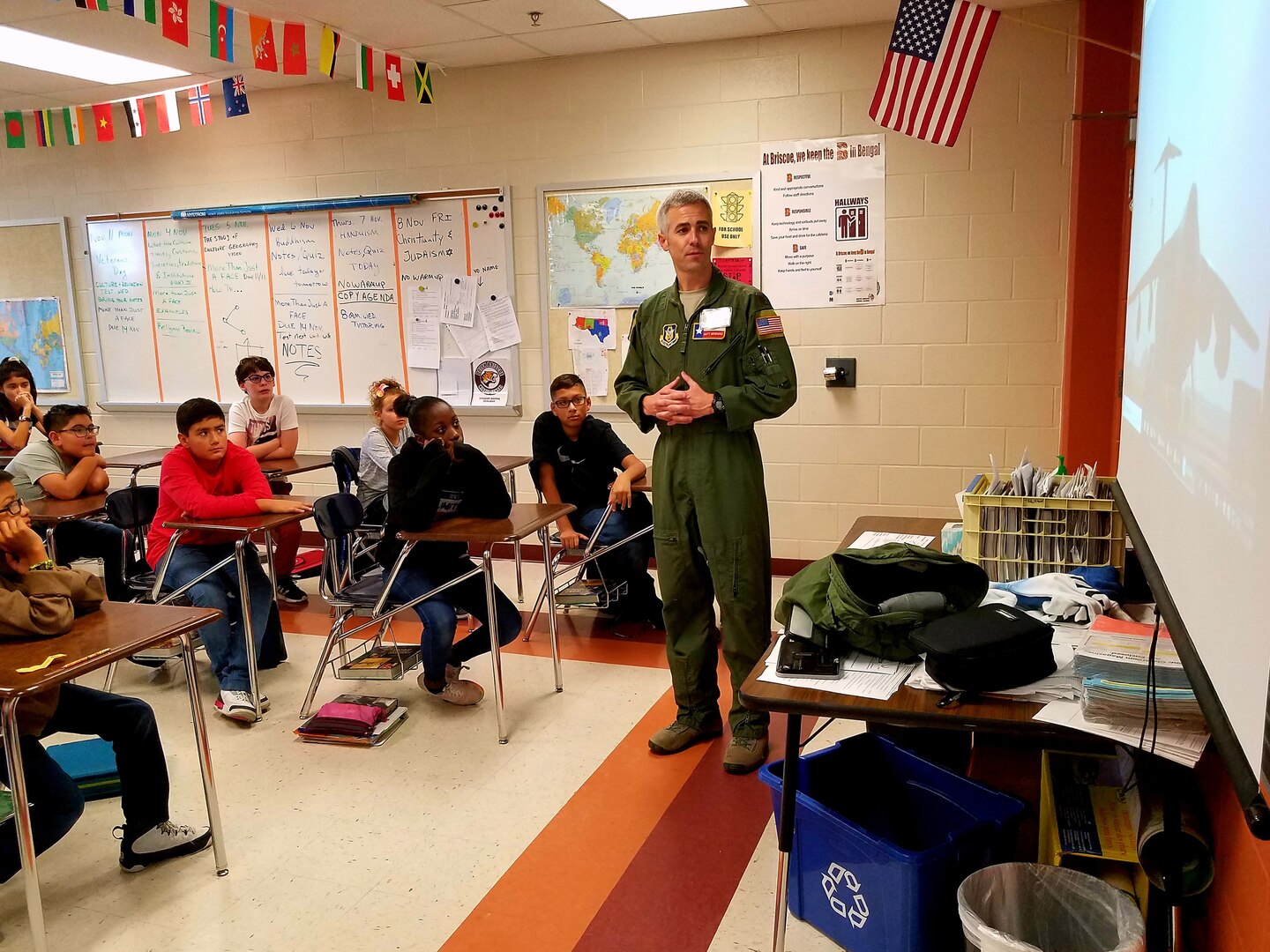 Maj. Matthew Menendez, 68th Airlift Squadron pilot, Joint Base San Antonio-Lackland, Texas briefs students from Dolph Briscoe Middle School, Nov. 11, 2019, on the mission of the 433rd Airlift Wing, and the facts about the aircraft they fly, the C-5M Super Galaxy.