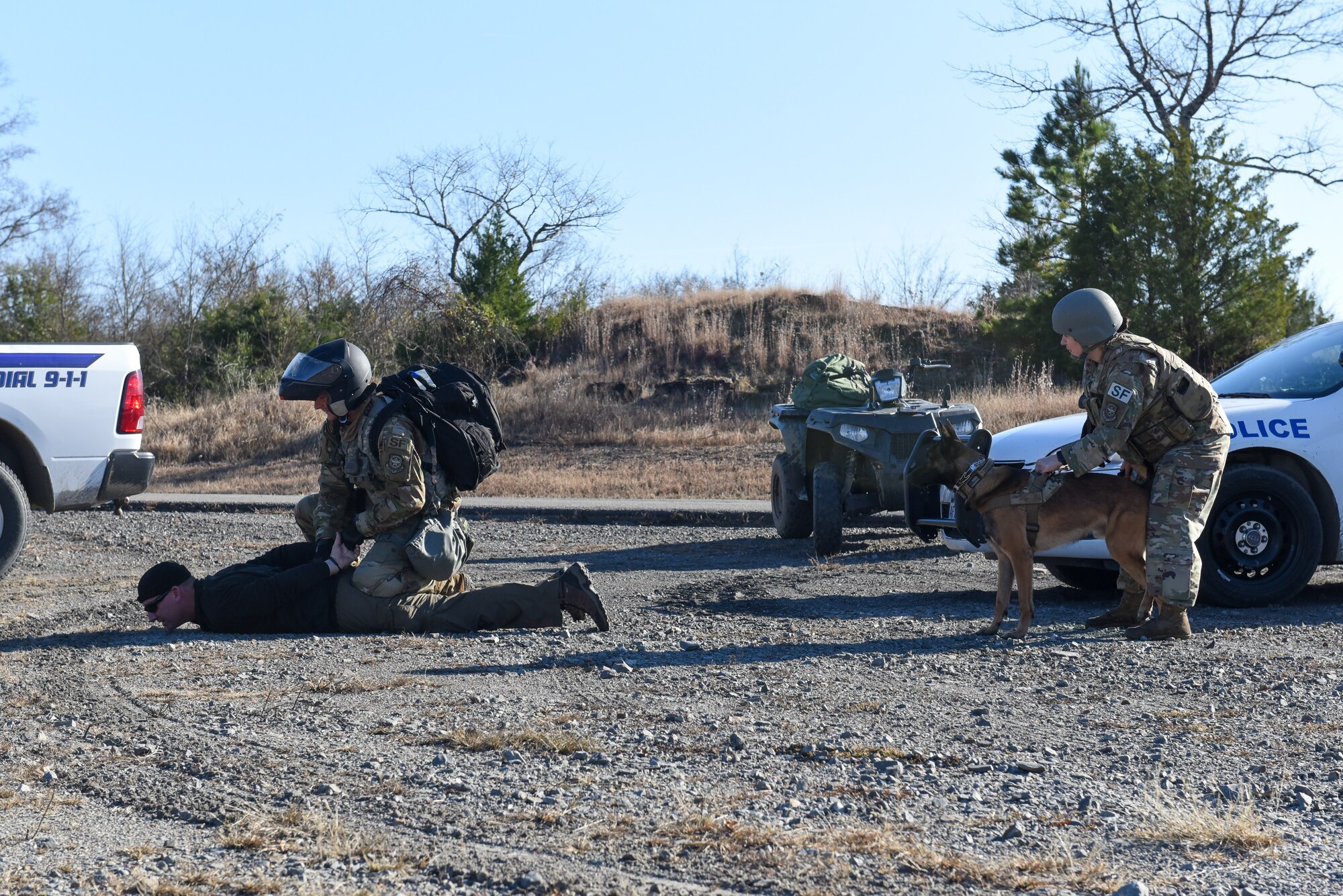 airmen from security forces and a military working dog take down an individual