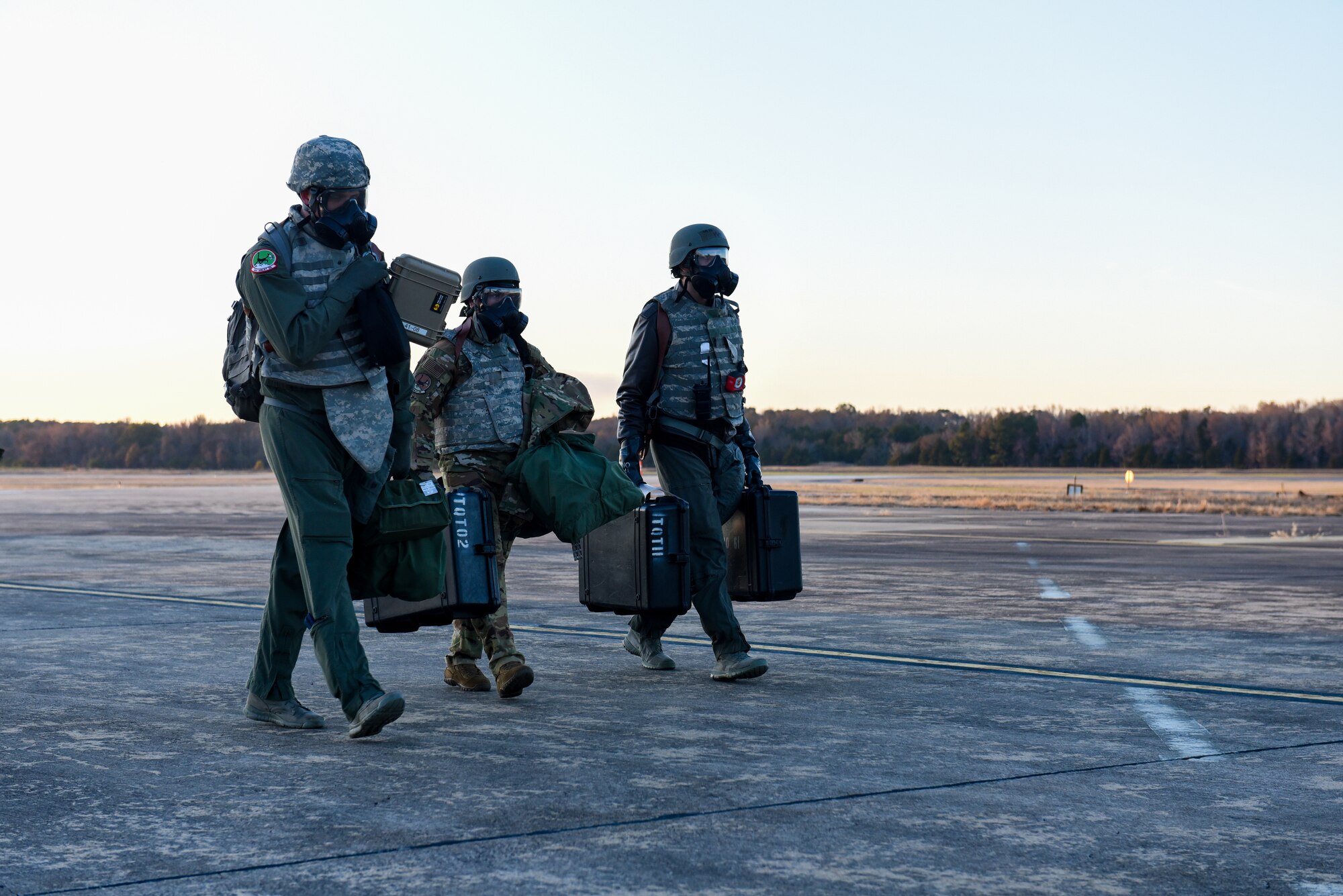 Aircrew walks away from a plane wearing gas masks