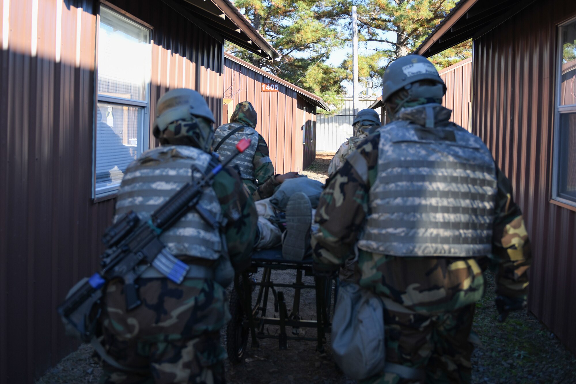 airmen carry a simulated patient on a stretcher