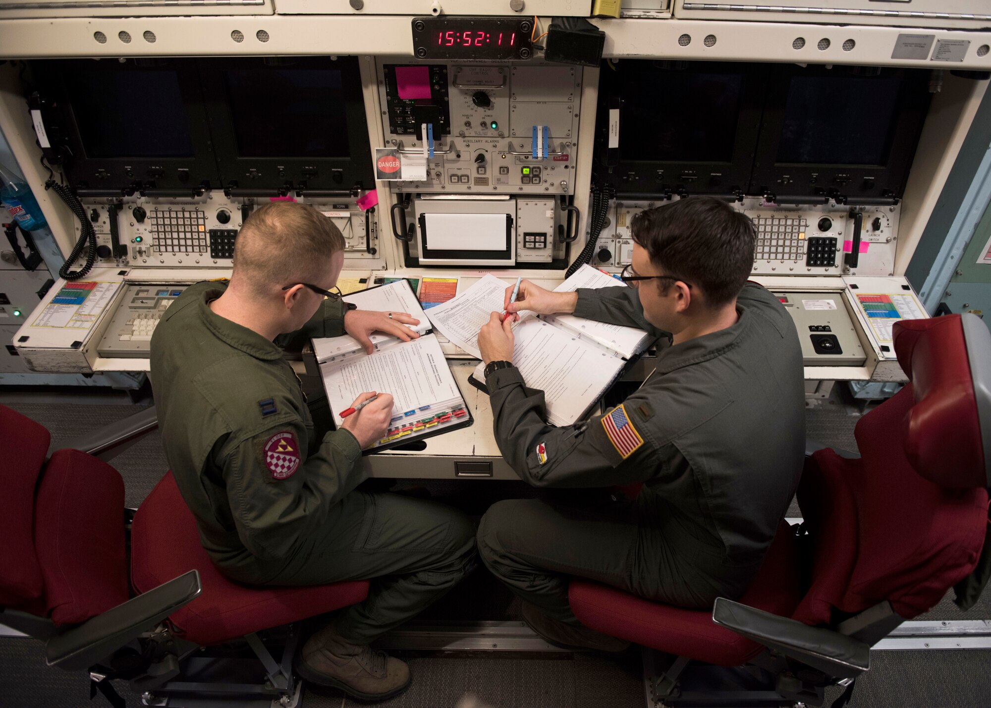Capt. Ben Shea, left, and 2nd Lt. Taylor Yost review missile alert facility checklists during Shea's first alert as an individual mobilization augmentee. (Photos by Senior Airman Alyssa M. Akers)