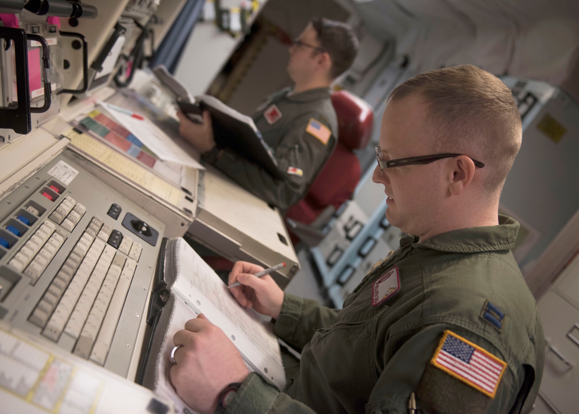 Capt. Ben Shea, right, and 2nd Lt. Taylor Yost review missile alert facility checklists during Shea's first alert as an individual mobilization augmentee. (Photos by Senior Airman Alyssa M. Akers)