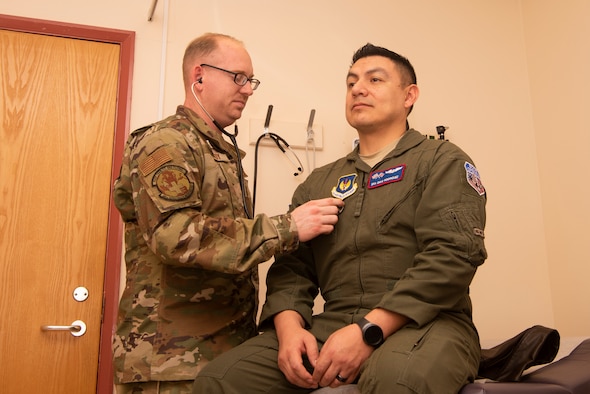 Staff Sgt. Zachary Gandy, 48th Aerospace Medicine Squadron flight operations medical technician, listens to the heartbeat of Senior Airman David Rodriquez, 351st Air Refueling Squadron boom operator, Nov. 19, 2019, at RAF Mildenhall, England. The clinic provides treatment to flyers so they are able to safely perform their in-air responsibilities. (U.S. Air Force photo by Airman 1st Class Joseph Barron)