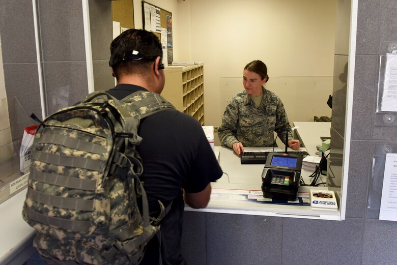 U.S. Air Force Senior Airman Bailey Hemphill, 39th Force Support Squadron postal clerk, processes a customer’s package for delivery, Nov. 20, 2019, at Incirlik Air Base, Turkey. With the holiday season approaching, the post office has experienced a high influx of mail being shipped and received. (U.S. Air Force photo by Staff Sgt. Eric Mann)