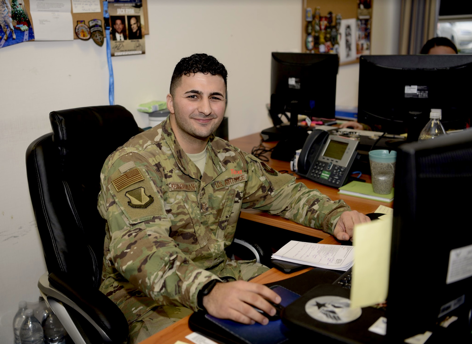 U.S. Air Force Staff Sgt. John Khandzhayan, a protocol liaison for the 86th Airlift Wing, poses for an on-the-job photo after receiving Airlifter of the Week, a Wing-level award recognizing Khandzhayan’s outstanding work performance, at Ramstein Air Base, Germany, Nov. 19, 2019. (U.S. Air Force photo by Senior Airman Sara Voigt)