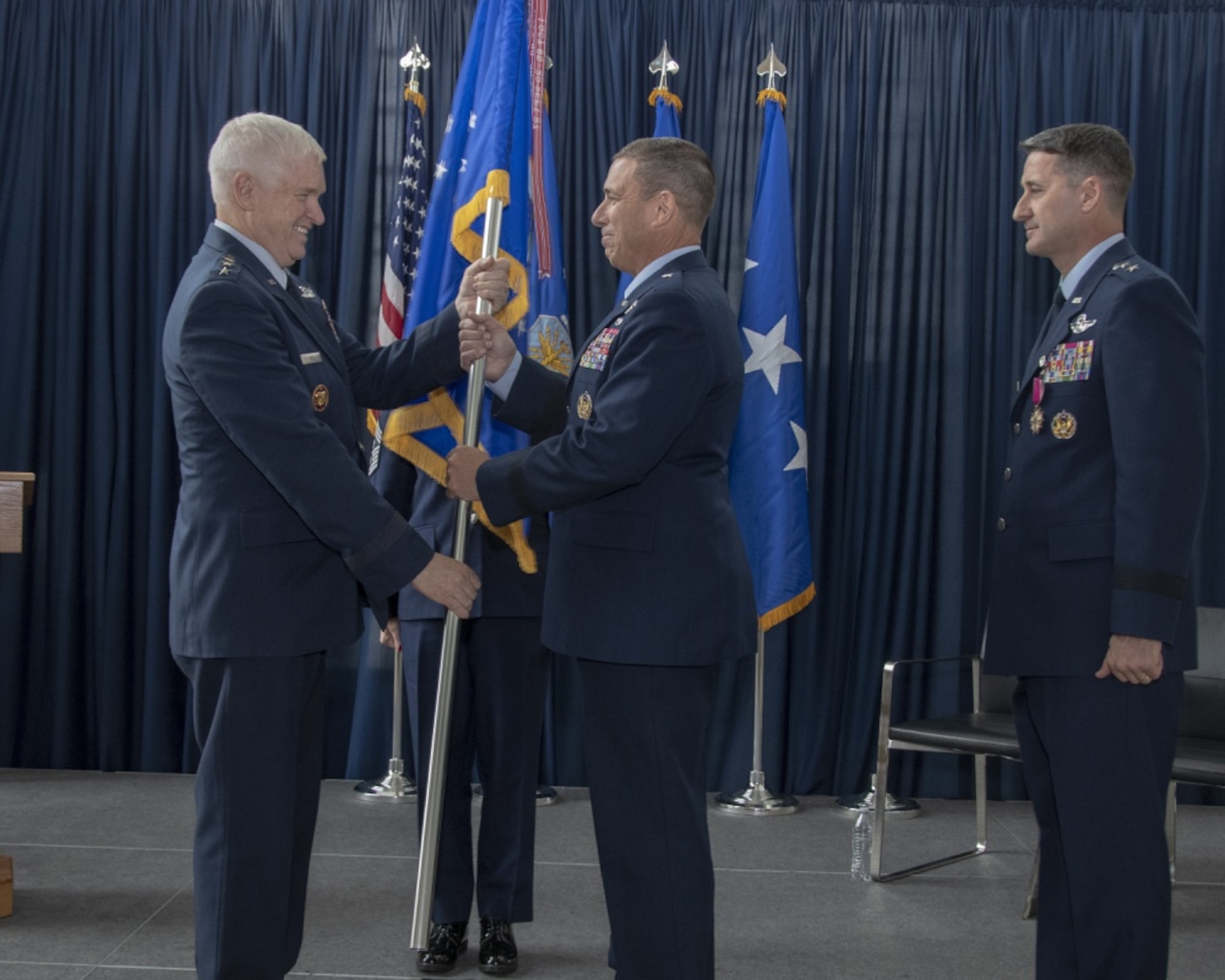 U.S. Air Force Lt. Gen. L. Scott Rice, Director, Air National Guard presents the unit flag to U.S. Air Force Brig. Gen. Frank M. Stokes as he assumes command of the Air National Guard Readiness Center (ANGRC) during a change of command ceremony Nov. 15, 2019, at Joint Base Andrews, Md. The change of command ceremony is military tradition that represents a formal transfer of authority and responsibility from one flag officer to another. (U.S. Air National Guard photo by Master Sgt. David J. Fenner)