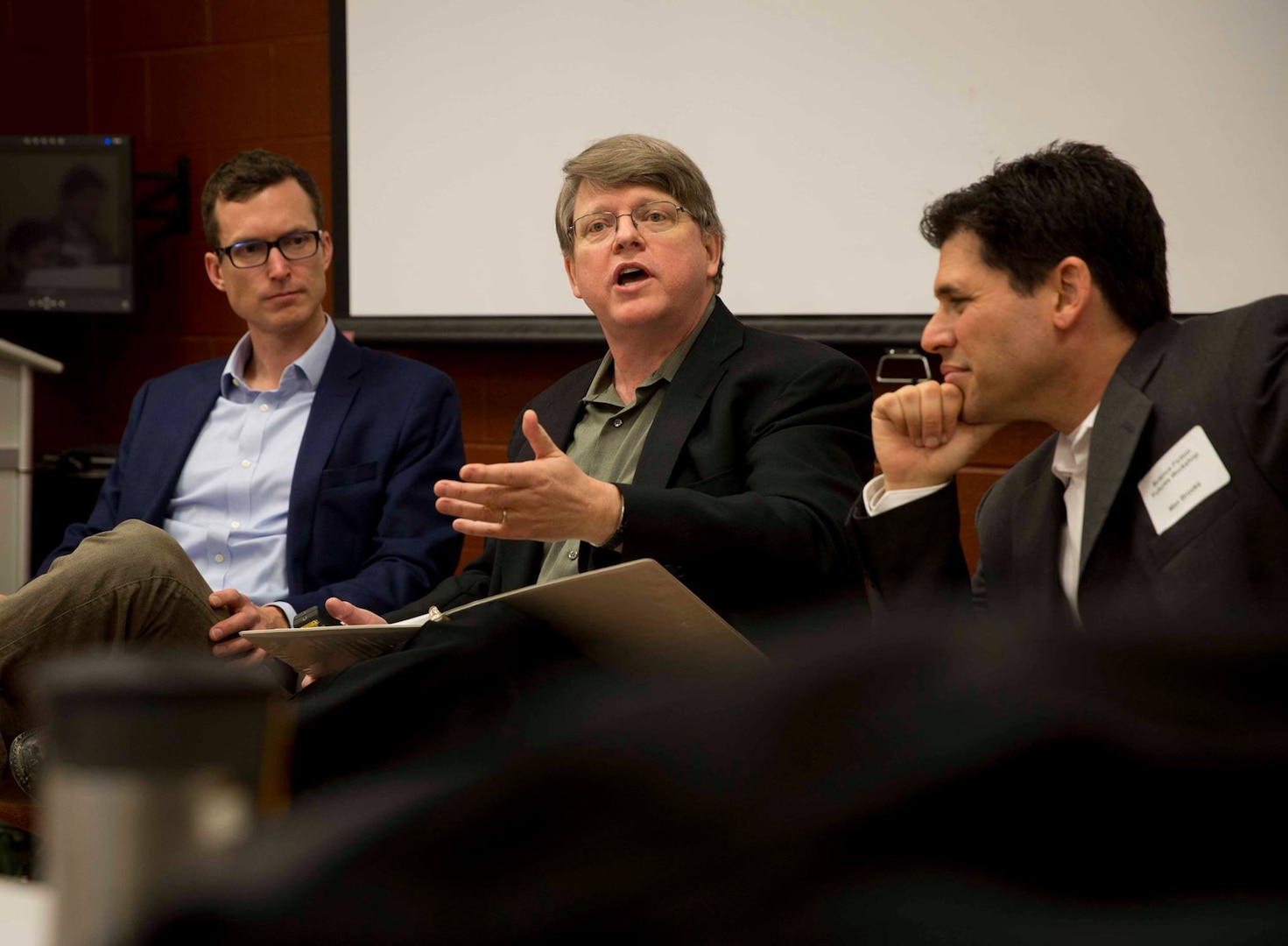 From left, August Cole, co-author of Ghost Fleet, Chuck Gannon, author of Trial by Fire, and Max Brooks, author of World War Z, talk with select group of burgeoning science fiction writers from across Department of Defense, February 4, 2019 (DOD/Kyle Olson)