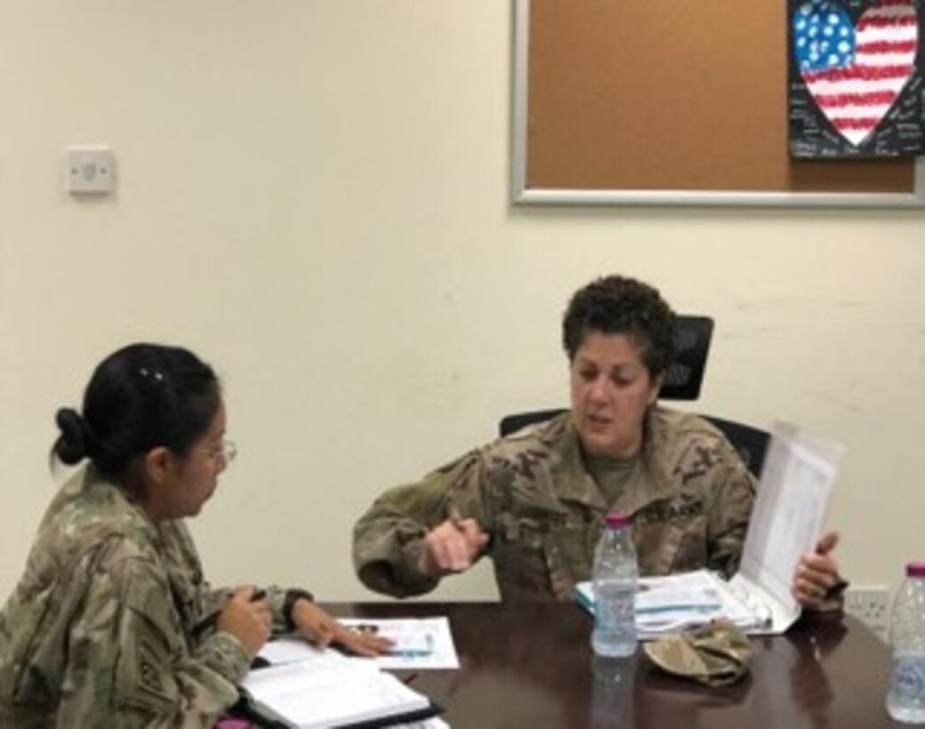 Capt. Mirianne Liakos discusses with Maj. Alexis Mendoza to plan nutrition classes in Qatar as part of the as part of the 3D MC (DS) Det. 1 FWD, Nutrition Care Team mission across the CENTCOM Area of Operation.