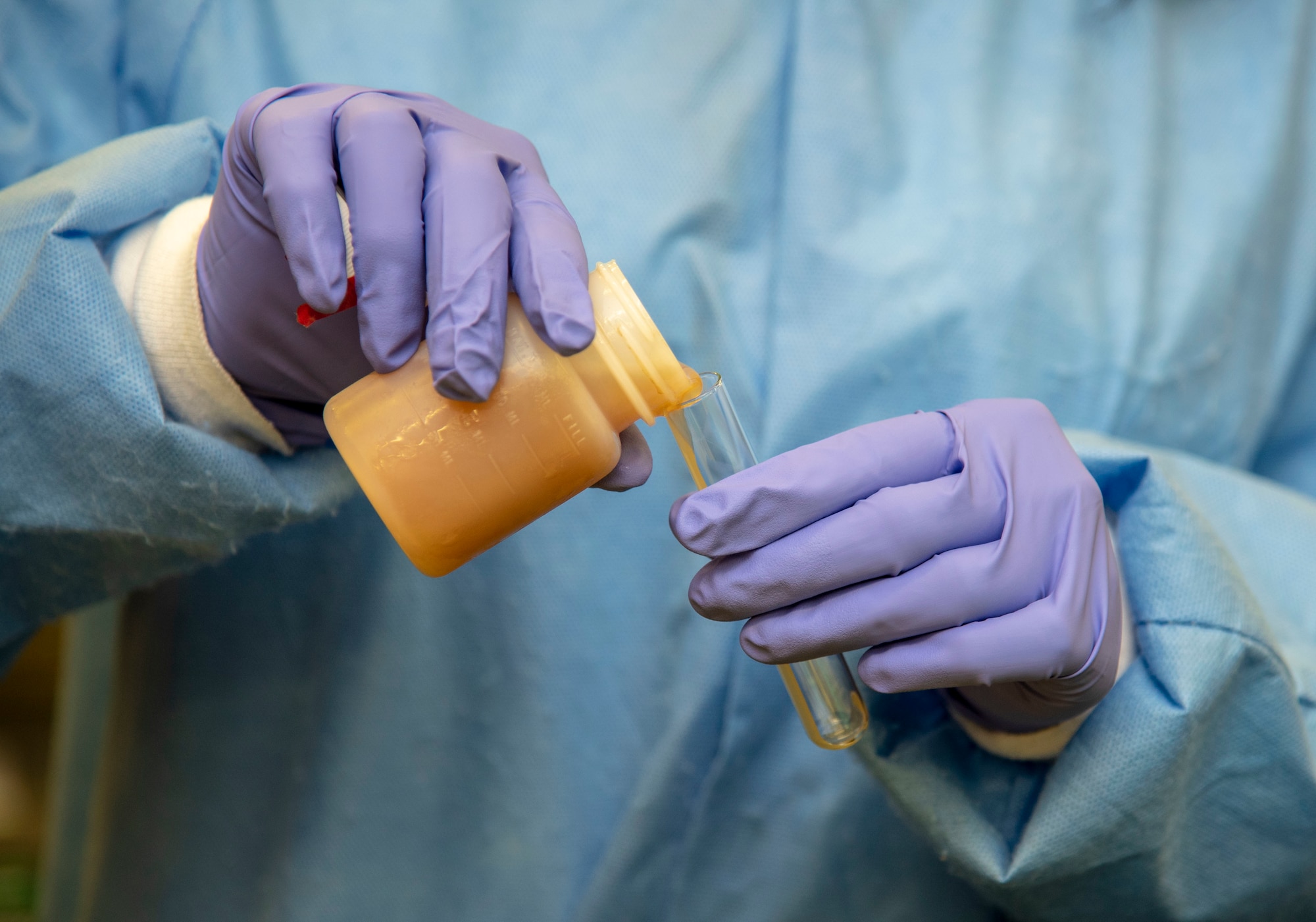 Tiara Evans, Armed Forces Medical Examiner System Forensic Toxicology analytical toxicologist 1, pours a small volume of urine to be tested October 31, 2019 at the AFMES Forensic Toxicology lab. The lab provides surveillance testing to Department of Defense and civilian populations to determine current drug trends and confirmation testing for the five service Drug Demand Reduction Program labs. (U.S. Air Force phot by Staff Sgt. Nicole Leidholm)