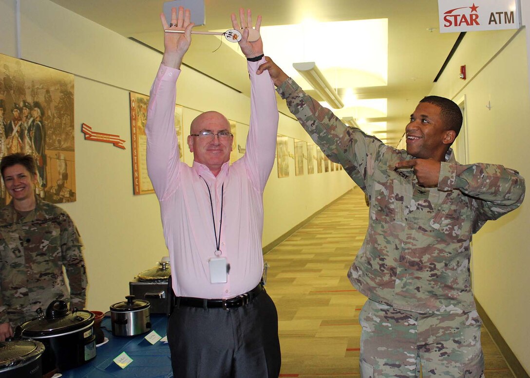 Army Col. Eric McCoy, right, director of the Subsistence supply chain at the Defense Logistics Agency Troop Support in Philadelphia, awards first place for the chili cook-off to Chris Mullen, a logistics systems analyst. The cook-off was held on Nov. 20 at DLA Troop Support headquarters in Philadelphia, and is an annual awareness event for the Combined Federal Campaign.