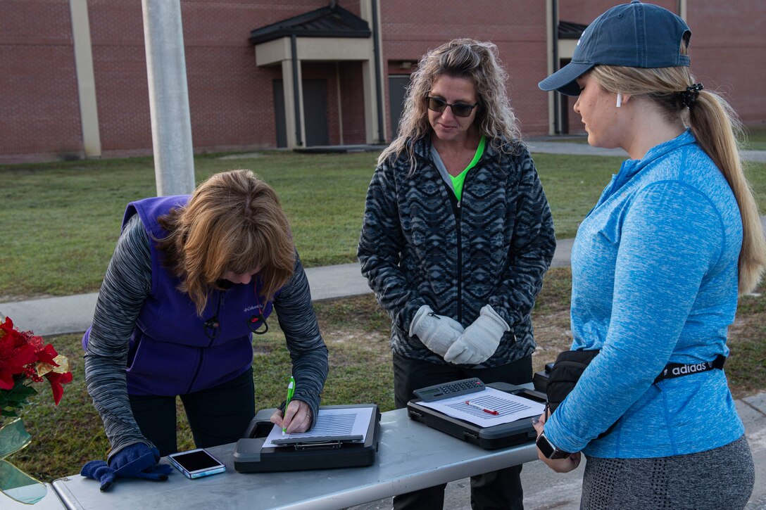 A photo of participants signing in to the Gobble 'Til You Wobble 5K