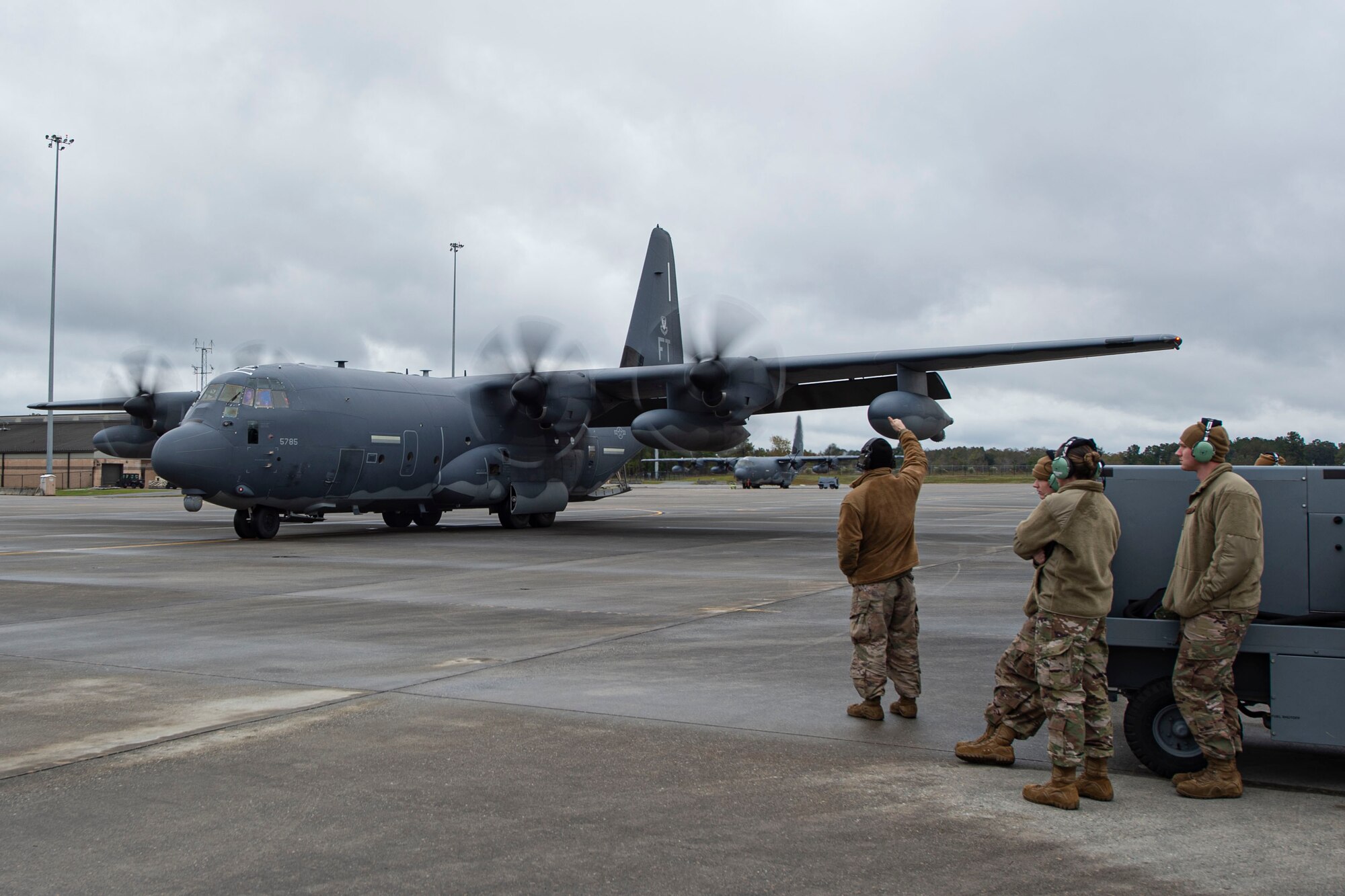 A photo of an Airman marshalling an aircraft.