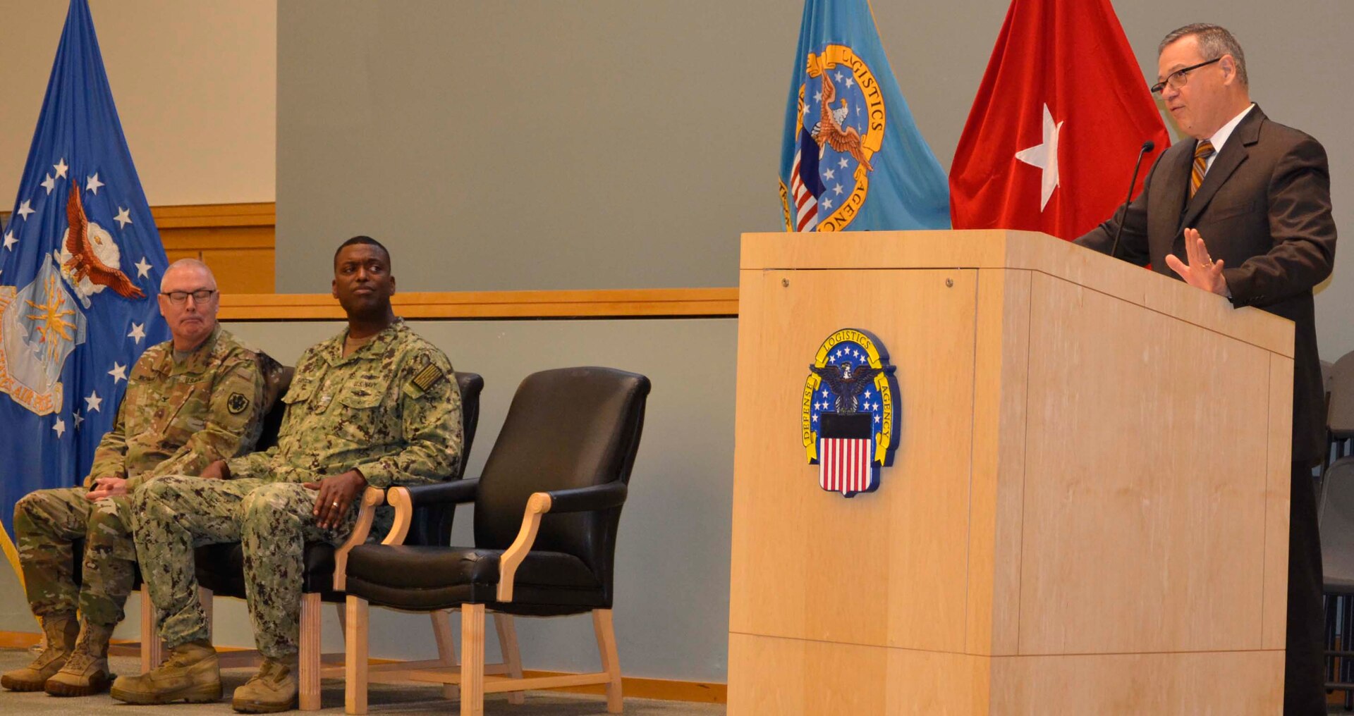 DLA Troop Support Deputy Commander Richard Ellis, right, shares personal testimony regarding the importance of resilience and work-life balance with employees alongside Procurement Process Support Director Navy Capt. James Gayton, center, and DLA Chaplain Army Col. Robert Wichman Nov. 21, 2019, in Philadelphia.