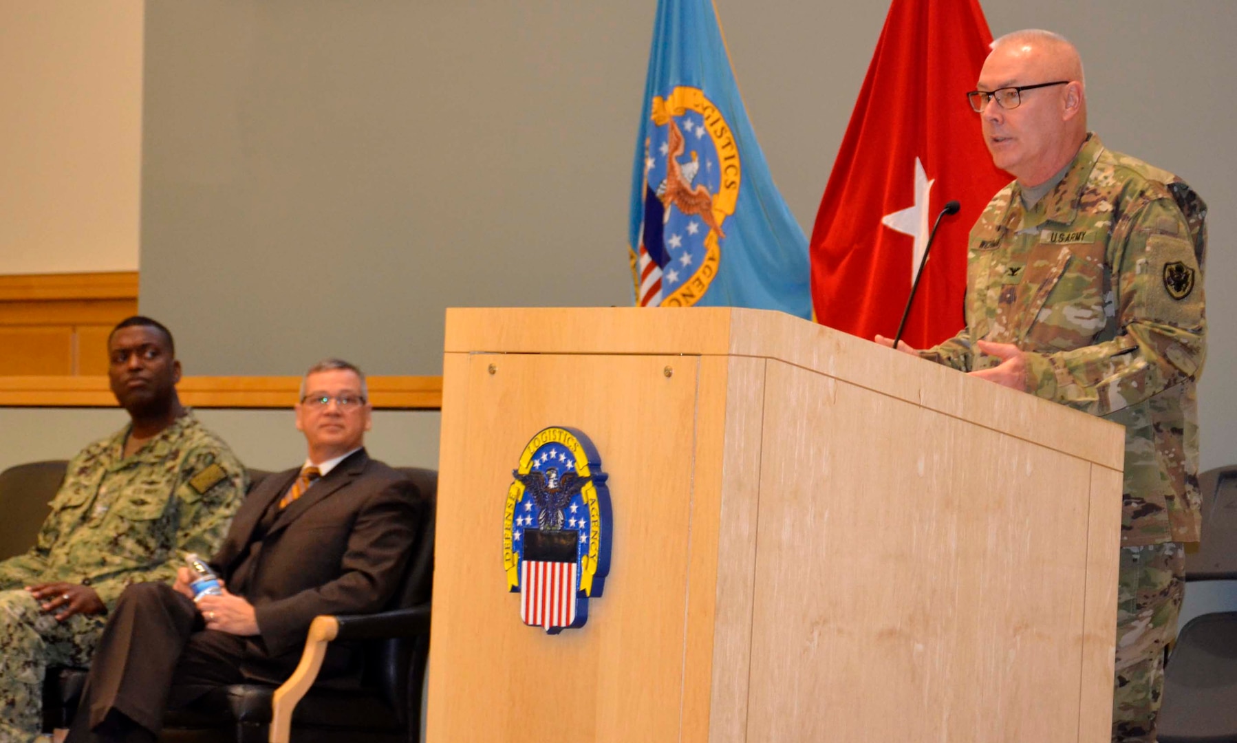 DLA Chaplain Army Col. Robert Wichman, right, speaks to employees at DLA Troop Support about the importance of resilience alongside Troop Support Deputy Commander Richard Ellis, center, and Procurement Process Support Director Navy Capt. James Gayton Nov. 21, 2019, in Philadelphia.