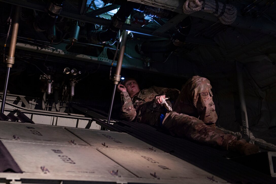 A photo of an Airman performing an inspection on an aircraft.