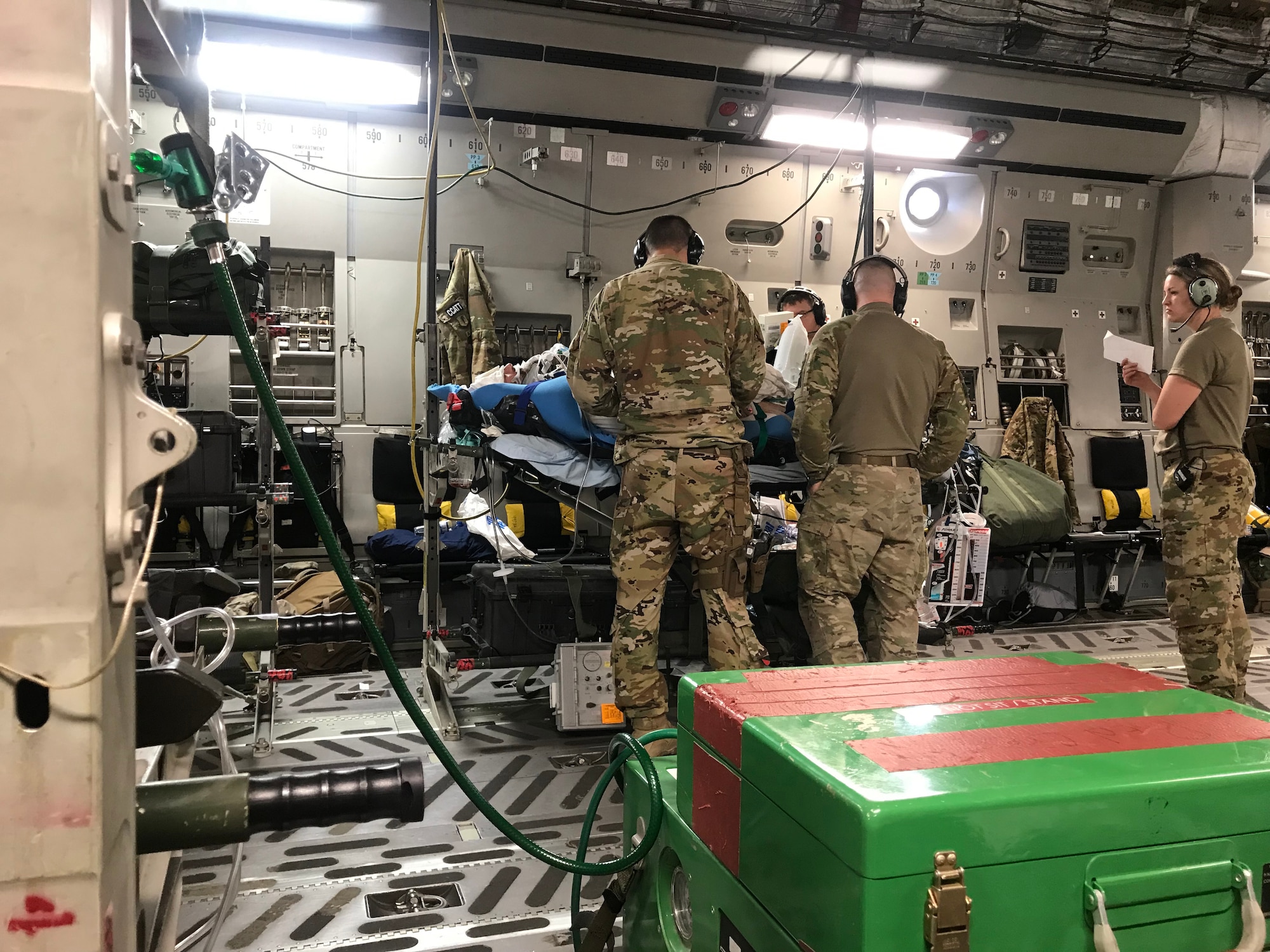 An Air National Guard Critical Care Air Transport Team, deployed from the 125th Fighter Wing, Florida Air National Guard, give medical attention to a patient during a six-month deployment to Bagram Airfield, Afghanistan. The CCATT’s mission is to transport critically injured service members from the point of injury to a hospital where they can receive the advanced care needed. (Courtesy Photo)
