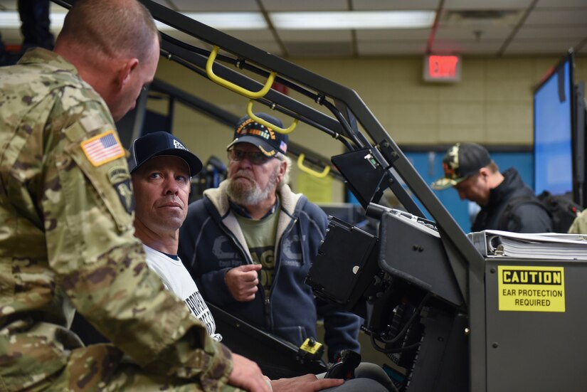 Robert Haydak, Cage Fury Fighting Championship president, and Rudy Ciancaglini learn about flight simulators at Joint Base Langley-Eustis, Virginia, Nov. 21, 2019.