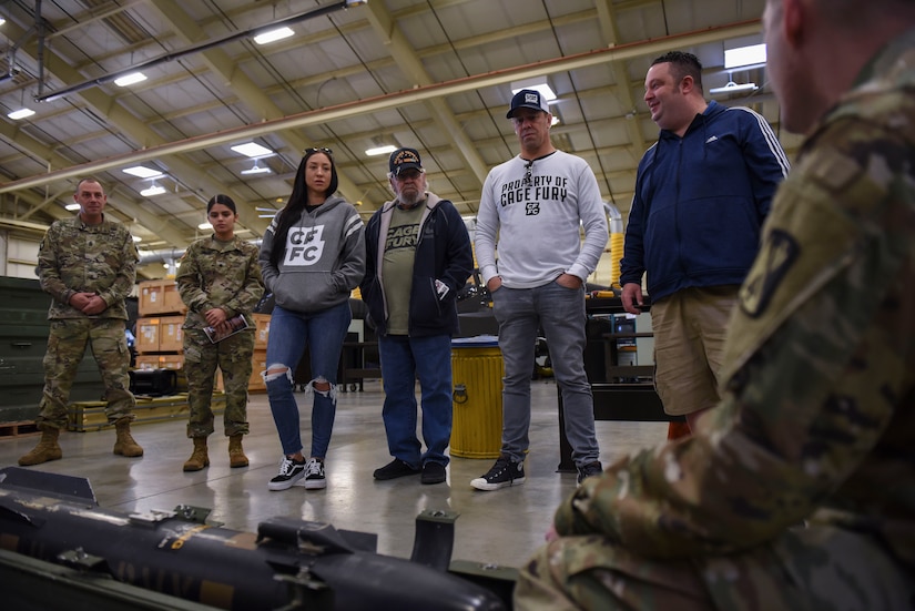 A U.S. Army Soldier briefs Cage Fury Fighting Championship representatives on CH-47 Chinook helicopter bomb at Joint Base Langley-Eustis, Virginia, Nov. 21, 2019.