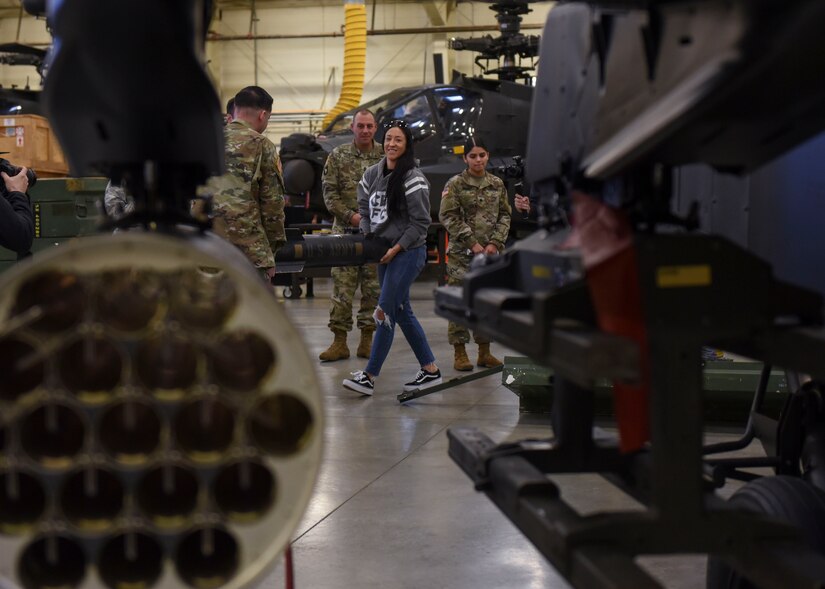 Jessica Penne, mixed martial arts fighter and Cage Fury Fighting Championship commentator, carries a CH-47 Chinook helicopter bomb at Joint Base Langley-Eustis, Virginia, Nov. 21, 2019.