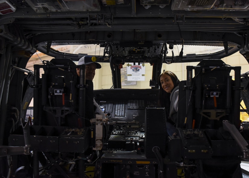 Robert Haydak, Cage Fury Fighting Championship president, and Jessica Penne, mixed martial arts fighter and CFFC commentator, sit inside a CH-47 Chinook training helicopter at Joint Base Langley-Eustis, Virginia, Nov. 21, 2019.