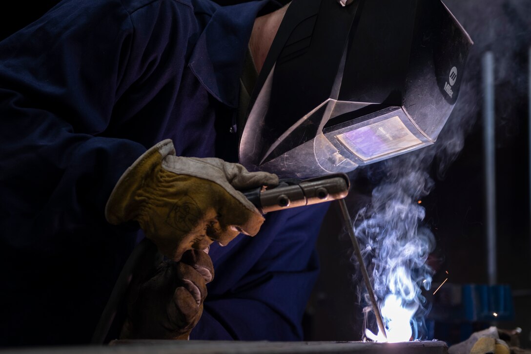 A photo of an engineering Airman welding a handrail