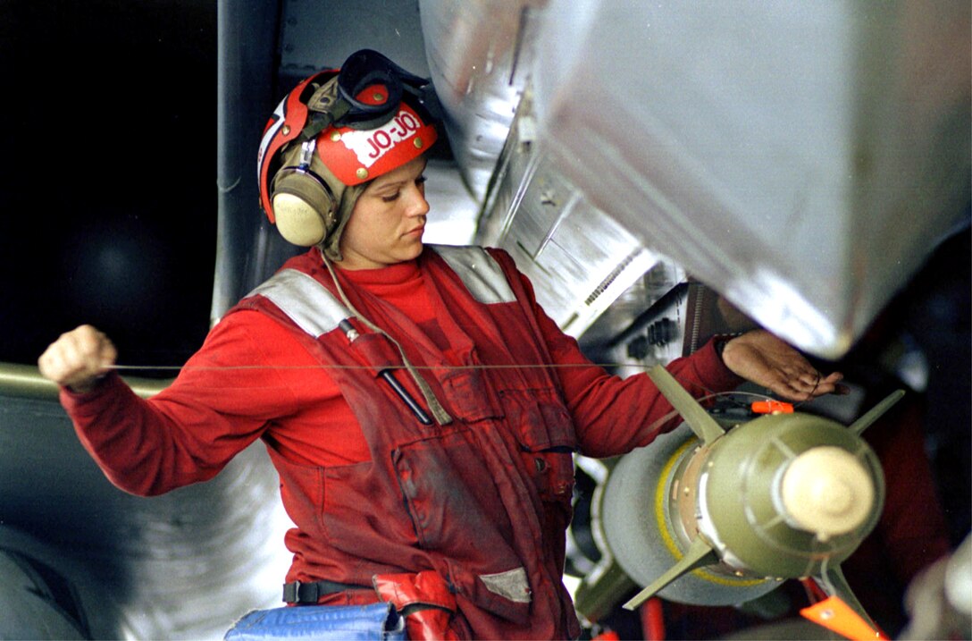 Aviation ordnanceman applies final wiring to GBU-24 laser-guided bomb attached to F-14 “Tomcat” fighter aircraft on board USS Theodore Roosevelt during Allied Force, Adriatic Sea, May 4, 1999 (U.S. Navy/Dennis Taylor)