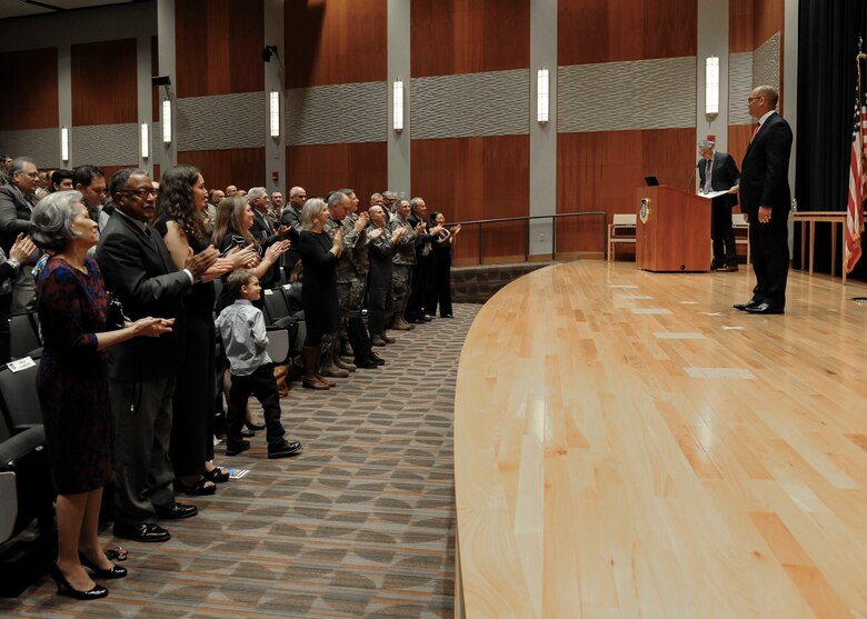 Duane Harrison, National Air and Space Intelligence Center’s newly inducted chief scientist, stands as the crowd gives him a standing ovation during the chief scientist induction ceremony Oct. 25, 2019. Harrison has worked at NASIC for over 18 years and became the eighth chief scientist in NASIC’s history. (U.S. Air Force photo by Senior Airman Samuel Earick)