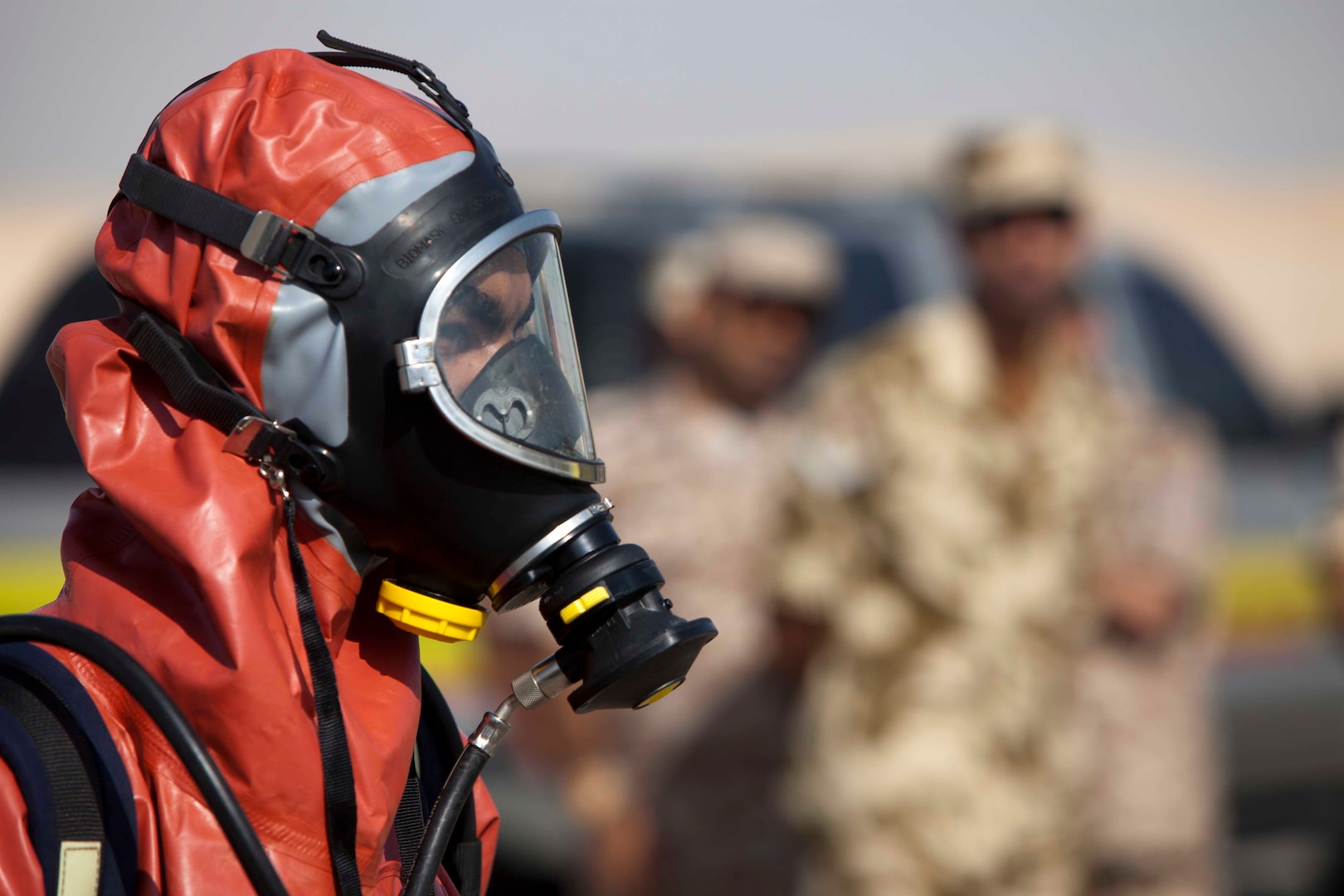 Bahrain Defense Force servicemember showcases protective chemical and biological protective suit to exercise participants of United Arab Emirates Union Defense Force, at Al Wathba, UAE training facility, as part of exercise Leading Edge, January 28, 2013 (U.S. Marine Corps/Leon M. Branchaud)
