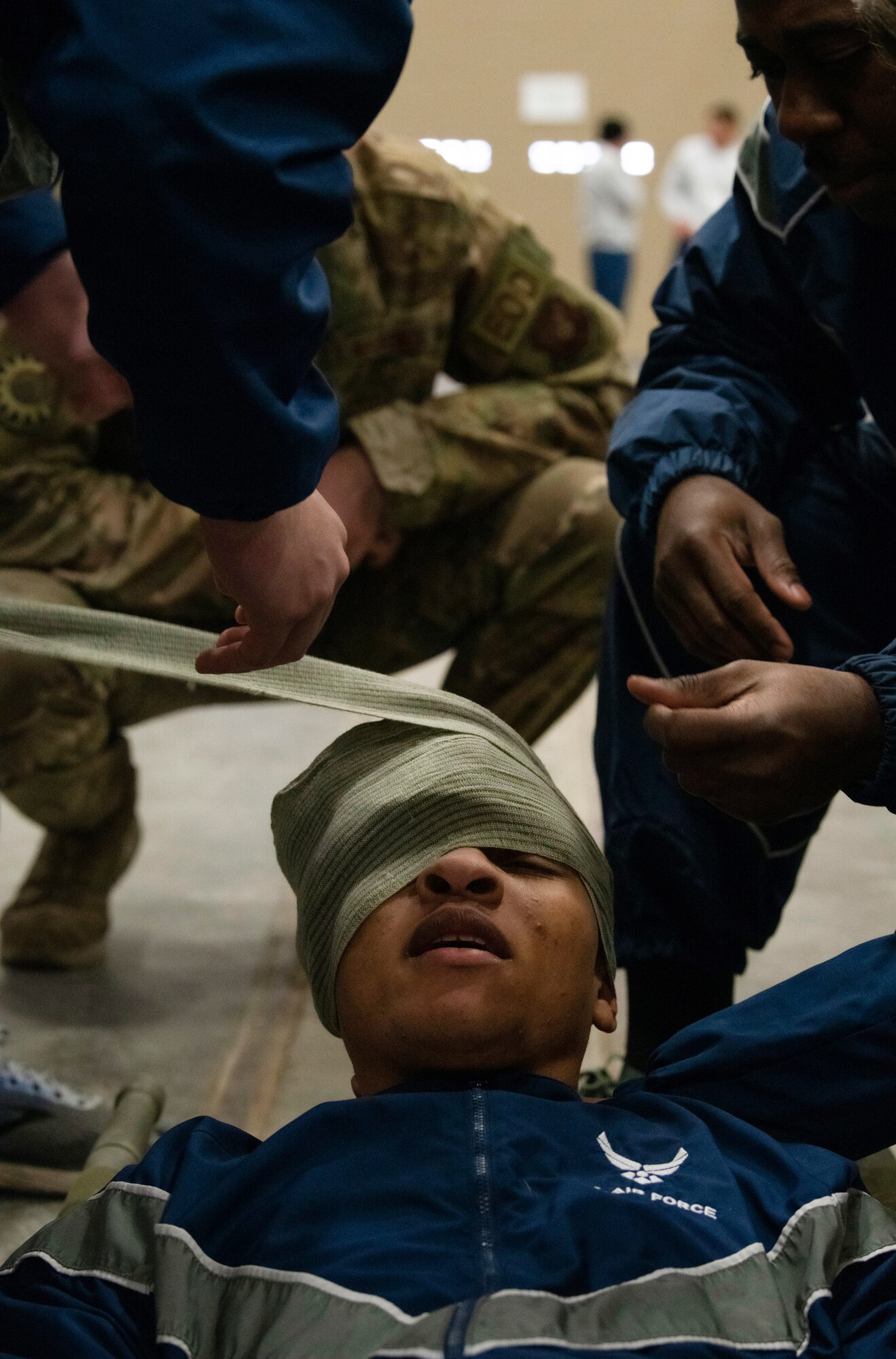 Airmen from the 90th Mission Support Group practice Self Aid Buddy Care skills during a friendly evaluation as part of a quarterly Warrior Day Nov. 21, 2019, on F.E. Warren Air Force Base, Wyo. The day’s events consisted of physical fitness, Self Aid Buddy Care skills, Chemical Biological Radiological Neurological evaluation, and Air Force knowledge, with 14 teams comprised of 90th MSG Airmen. (U.S. Air Force photo by Senior Airman Abbigayle Williams)