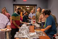 Members of Joint Task Force Civil Support (JTF-CS) and their families get food during the JTF-CS Thanksgiving pot-luck at the command headquarters at Joint Base Langley-Eustis. JTF-CS Morale, Welfare and Recreation (MWR) hosts this event every year to promote comradery, morale and well-being for command personnel, as well as to give their family members a chance to see what JTF-CS is all about. (Official DoD photo by Mass Communication Specialist 3rd Class Michael Redd/RELEASED)