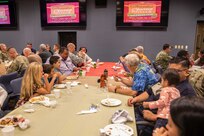 Members of Joint Task Force Civil Support (JTF-CS) and their families eat food and socialize during the JTF-CS Thanksgiving pot-luck at the command headquarters at Joint Base Langley-Eustis. JTF-CS Morale, Welfare and Recreation (MWR) hosts this event every year to promote comradery, morale and well-being for command personnel, as well as to give their family members a chance to see what JTF-CS is all about. (Official DoD photo by Mass Communication Specialist 3rd Class Michael Redd/RELEASED)