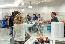 Photo of employees being served dinner.