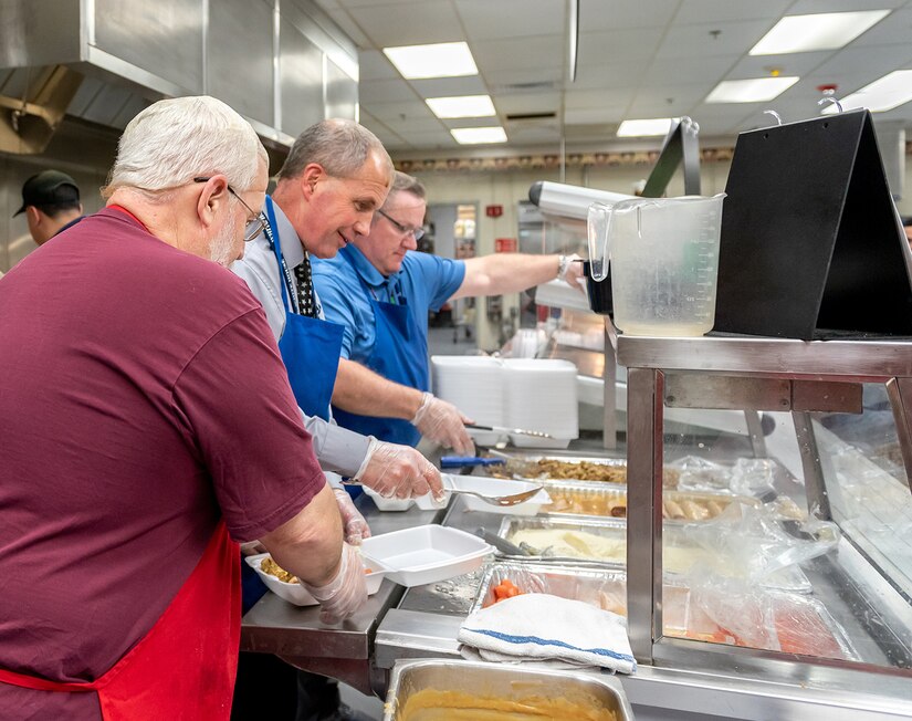 Photo of employees being served dinner.