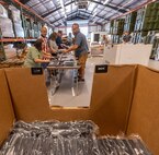 Photo of depot employees preparing thin client devices for distribution
