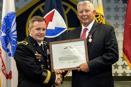 Brig. Gen. Mark S. Bennett, U.S. Army Financial Management Command commanding general, presents Joseph Myrda, USAFMCOM financial systems analyst, with an Army Superior Civilian Service Medal during Myrda’s retirement ceremony in Indianapolis Nov. 21, 2019. Enlisting in the Army in 1963, Myrda served three tours in Vietnam, retired from the military as a command sergeant major in 1992, and served in a civil servant and a recognized expert in disbursing operations across the Army until his civilian retirement. (U.S. Army photo by Mark R. W. Orders-Woempner)