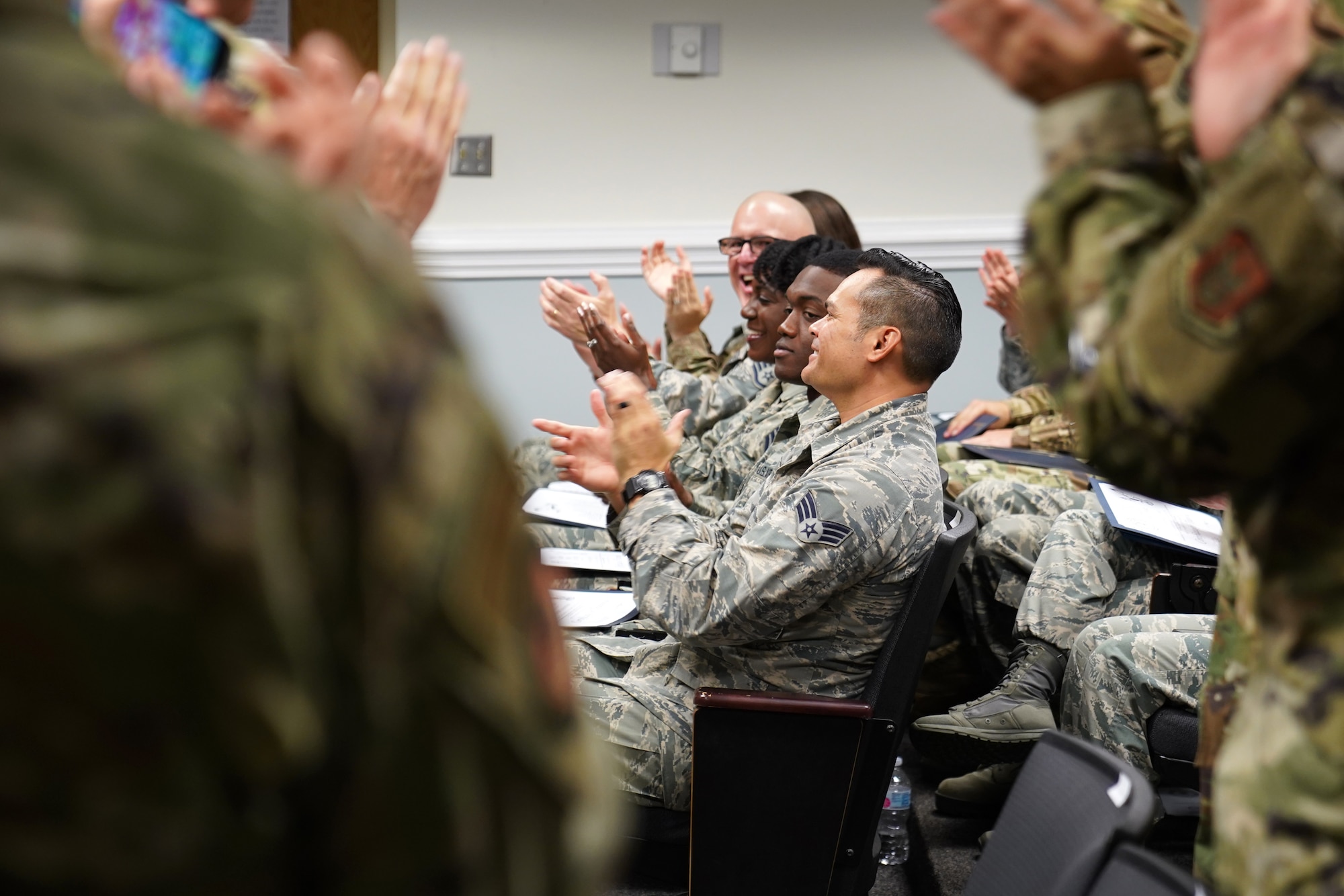 Chaplain Corps leadership applaud religious affairs course students during their graduation inside Wolfe Hall at Keesler Air Force Base, Mississippi, Nov. 22, 2019. The six-week course was relocated and revamped to improve the quality of training for students. (U.S. Air Force photo by Airman Seth Haddix)