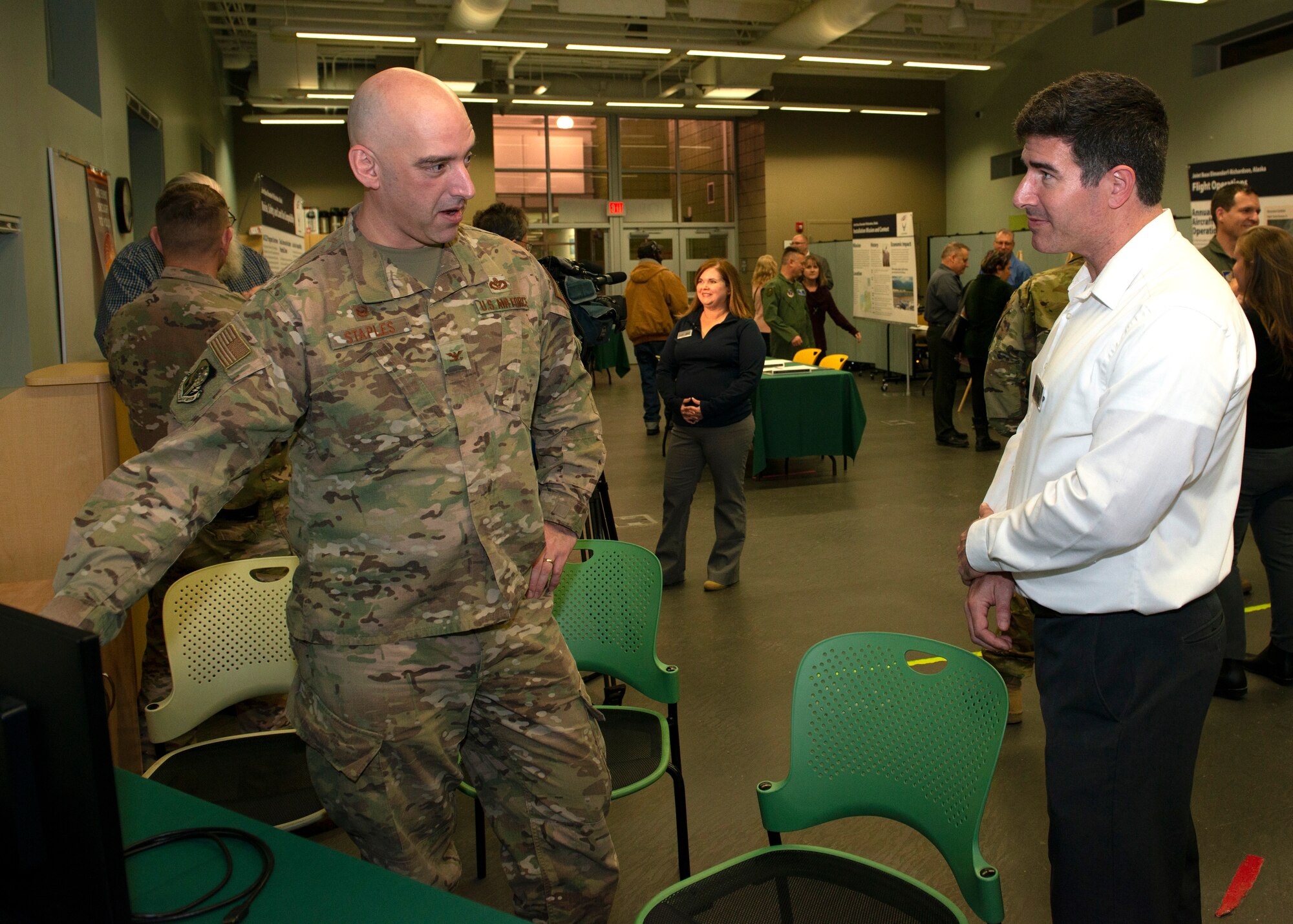 U.S. Air Force Col. Michael Staples, 673d Civil Engineer Group commander, talks about noise contours with Jay Austin, an environmental analyst with Leidos, during an Air Installation Compatible Use Zone study open house in Anchorage, Alaska, Nov. 20, 2019. Joint Base Elmendorf-Richardson, Alaska, hosted the event, which showed the results of the study, to promote transparency between the installation and its community partners.