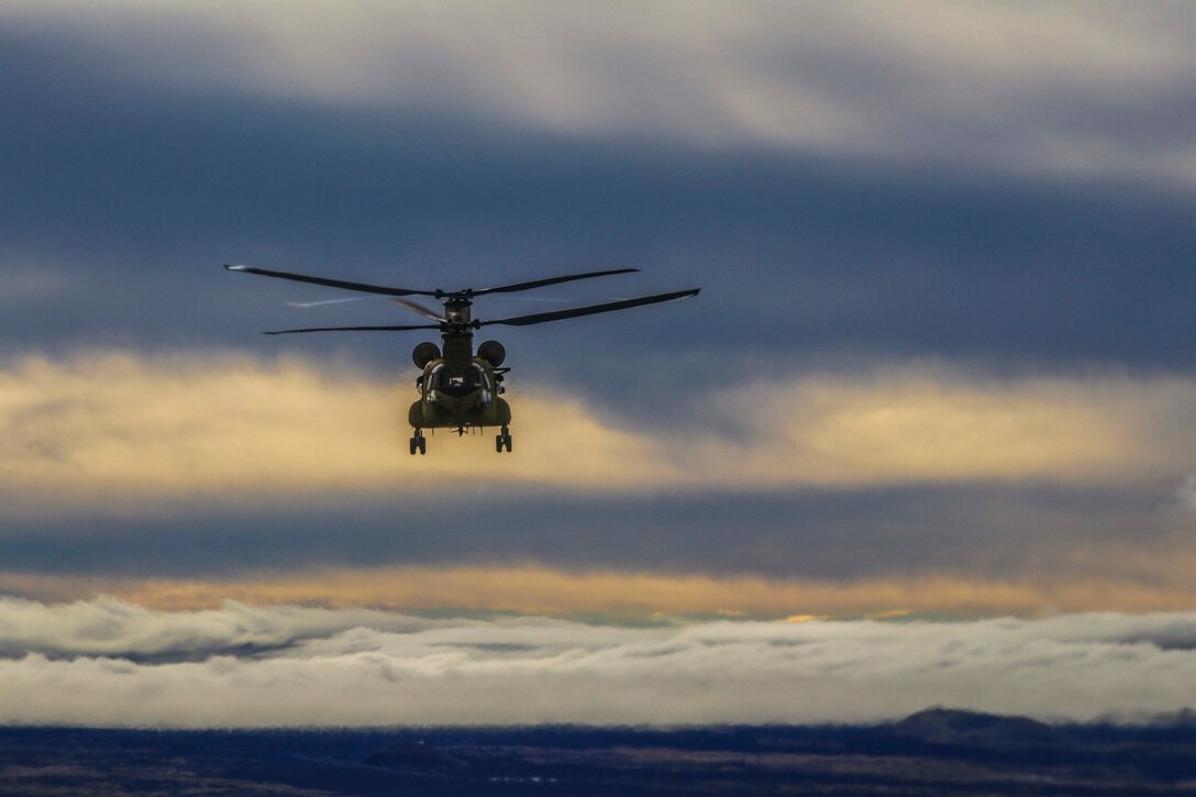 A helicopter flies through the sky.