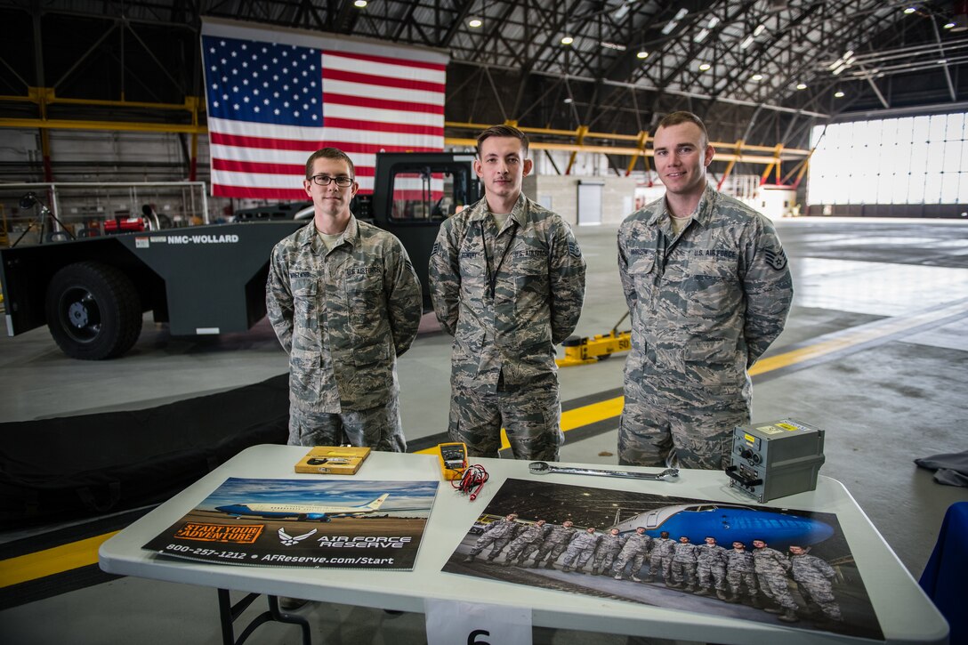 Senior Airman Landon Wineland, left, Staff Sgt. Robert Gentry, center, and Staff Sgt. Blake Harrison, all with the  932nd Airlift Wing Maintenance Squadron, pose for a photo after having shared their Air Force stories with students during STEAM Day at Scott Air Force Base, Illinois, Nov. 20, 2019. They spoke about maintenance careers within the Air Force Reserve Command and challenged students to fold and fly paper airplanes. The STEAM Day event inspires kids to explore and pursue their interests in Science, Technology, Engineering, Art and Math. (U.S. Air Force photo by Christopher Parr)