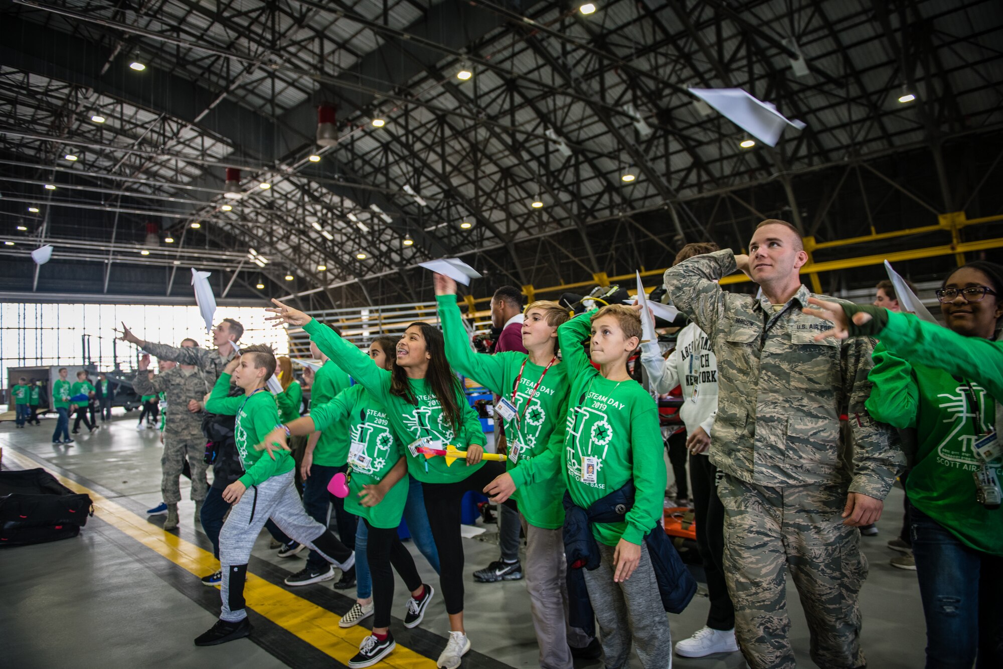 Staff Sgt. Blake Harrison, 932nd Airlift Wing Maintenance Squadron technician, joins STEAM Day local school students as they compete for the longest flight with a paper airplane during during the STEAM Day event at Scott Air Force Base, Illinois, Nov. 20, 2019. The day inspires kids to explore and pursue their interests in Science, Technology, Engineering, Art and Math.
(U.S. Air Force photo by Christopher Parr)