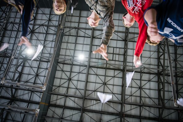 Staff Sgt. Robert Gentry, 932nd Airlift Wing Maintenance Squadron technician, joins STEAM Day local school students as they compete for the longest flight with a paper airplane during during the STEAM Day event at Scott Air Force Base, Illinois, Nov. 20, 2019. The day inspires kids to explore and pursue their interests in Science, Technology, Engineering, Art and Math.
(U.S. Air Force photo by Christopher Parr)