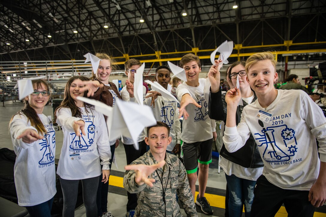 Staff Sgt. Robert Gentry, 932nd Airlift Wing Maintenance Squadron technician, speaks with students about maintenance careers within the Air Force Reserve and challenges students to create and fly paper airplanes during STEAM Day at Scott Air Force Base, Illinois, Nov. 20, 2019. The day inspires kids to explore and pursue their interests in Science, Technology, Engineering, Art and Math. (U.S. Air Force photo by Christopher Parr)