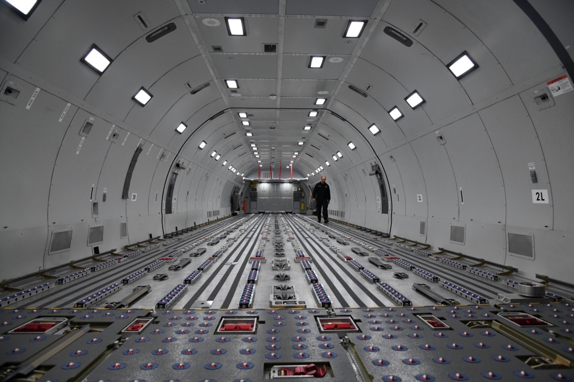 Bradford Voorhees, 22nd Civil Engineering Squadron A shift captain, walks along the interior of a KC-46 fuselage trainer Nov. 12, 2019 at McConnell Air Force Base, Kan. The fuselage is typically used by boom operators for quarterly cargo load training, allowed participants in the training to get hands on experience operating the interior of a KC-46. (U.S. Air Force photo by Airman 1st Class Nilsa E. Garcia)