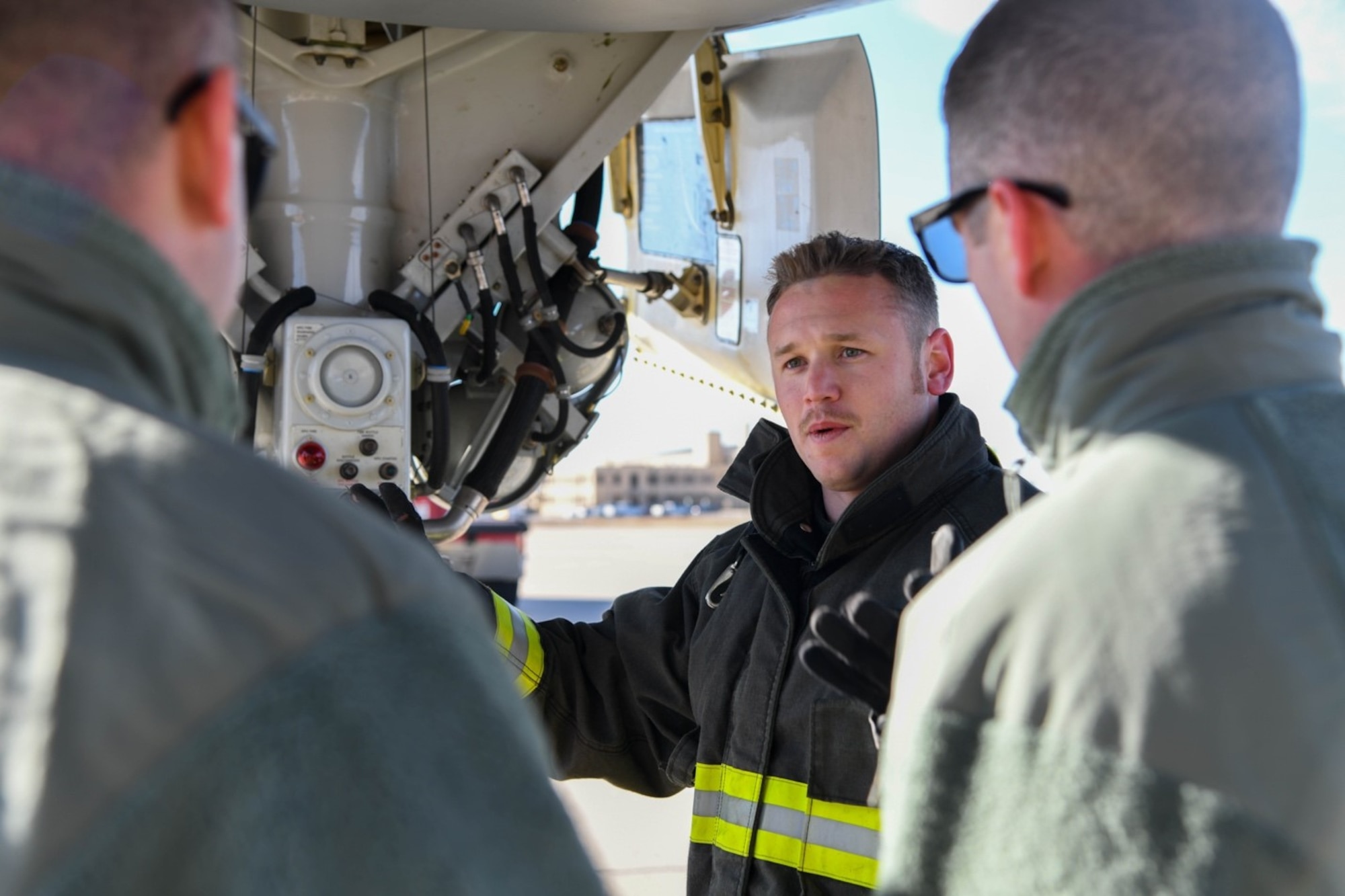 William Turner, 22nd Civil Engineering Squadron fire fighter, displays the auxiliary power unit fuel shut-off on the backside of the front landing gear Nov. 13, 2019 at McConnell Air Force, Kan. Participants in the KC-46 Firefighter Symposium had the opportunity to tour the interior and exterior of the aircraft as part of the live-demonstration training. (U.S. Air Force photo by Airman 1st Class Nilsa E. Garcia)